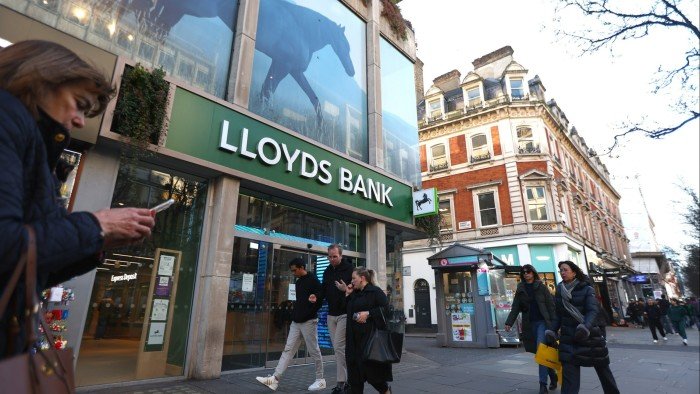 People walk past a branch of Lloyds Bank on Oxford street, London