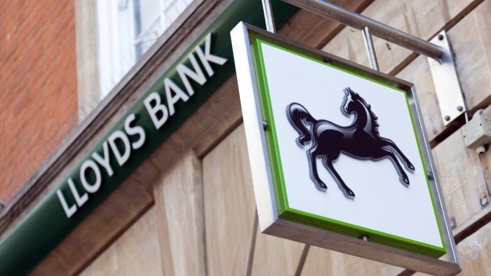 A sign for Lloyds Bank featuring the black horse logo is displayed outside a branch in Chelmsford, UK