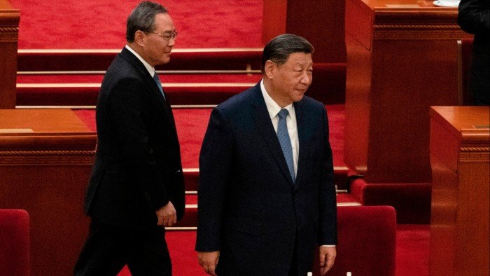 Xi Jinping and Li Qiang walk to their seats at the Great Hall of the People