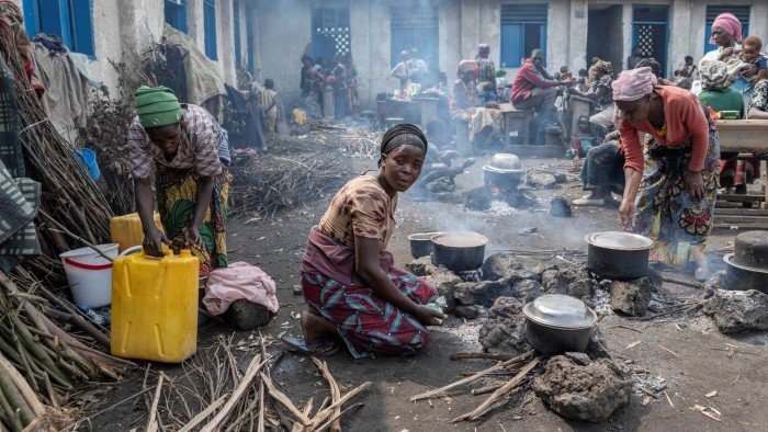 A woman prepares food for her internally displaced Congolese family