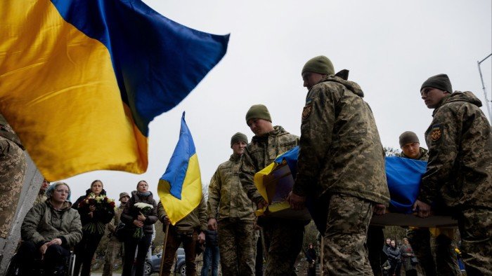 Ukrainian soldiers carry the coffin of a fallen comrade during a funeral in Kyiv on Tuesday