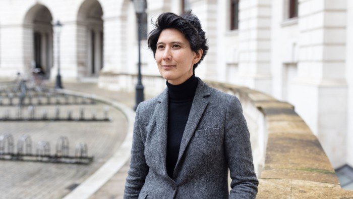 Senior civil servant Cat Little standing in front of a government building