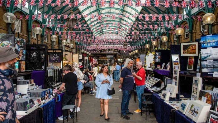 Shoppers browse market stalls in Covent Garden