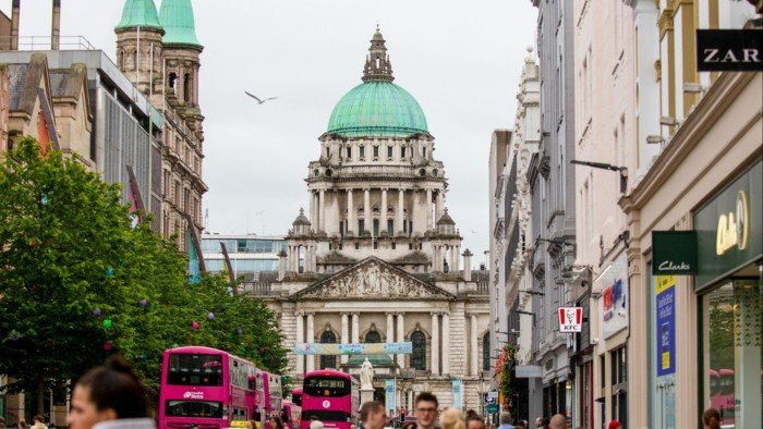 Shoppers on Donegall Place in view of the Belfast City Hall in central Belfast