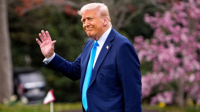 Donald Trump waves while walking on the South Lawn of the White House
